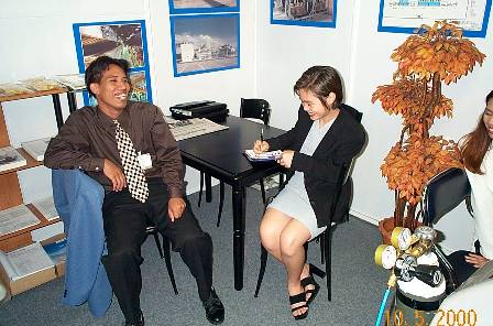 Khun Pong and Khun Dee doing some statistics and customer follow up, in the background photos visible from our partner and shareholder Air Engineering, Solvent recovery systems, dryers for the converting industry and air pollution abatement systems