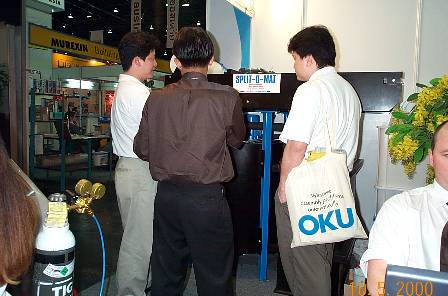 Customers carefully listening to Khun Pong, who is explaining the function of the SOM1100 system